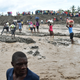 Haitian people cross the river La Digue in Petit Goave where the bridge collapsed during the rains from Hurricane Matthew, southwest of Port-au-Prince, October 6, 2016. Hurricane Matthew has left at least 23 people dead in Haiti, a toll likely to climb as authorities re-establish contact with the hardest-hit areas where the damage is ‘catastrophic,’ officials said. The Caribbean’s worst storm in nearly a decade, Matthew slammed into Haiti, the Americas’ poorest nation, with heavy rains and devastating winds triggering severe flooding and mud slides. (Image: Getty)